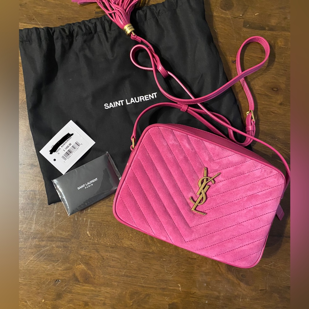 Yves Saint Laurent Rose colored purse with tassels.